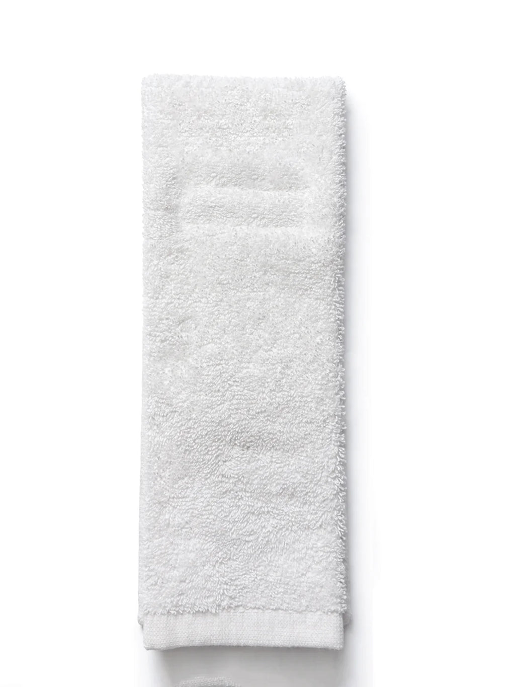 A folded white cotton towel with a soft, plush terry texture, shown vertically against a plain white background.